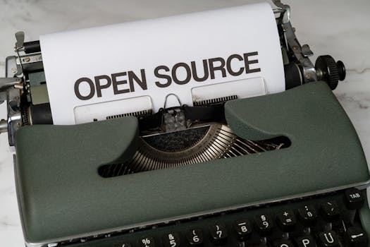 Close-up of a vintage typewriter with 'Open Source' typed on paper, conveying creativity.